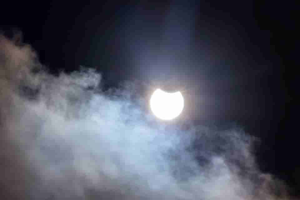 Image of Partial Eclipse behind Clouds.